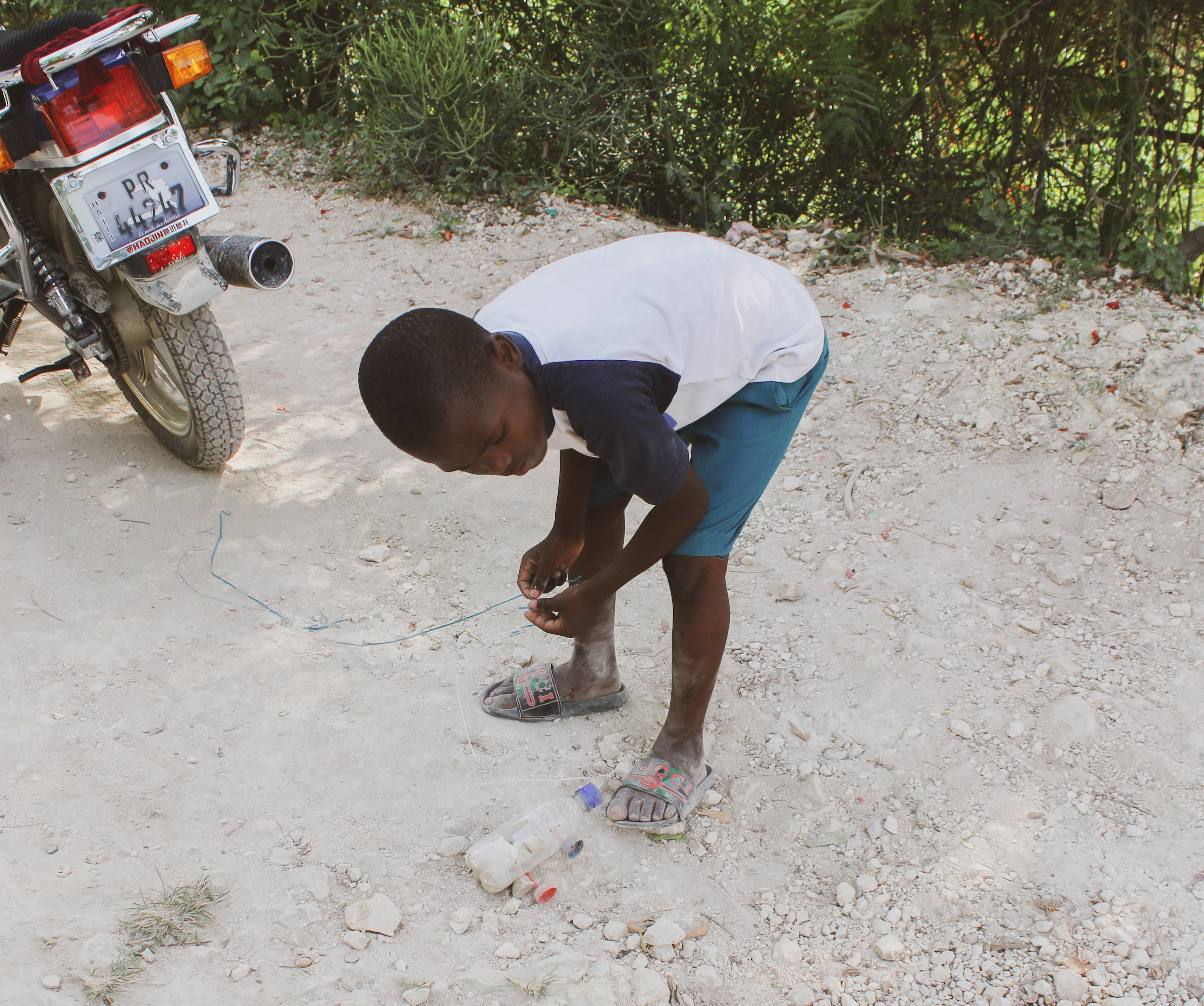 Kid with Homemade Bottle Car Toy